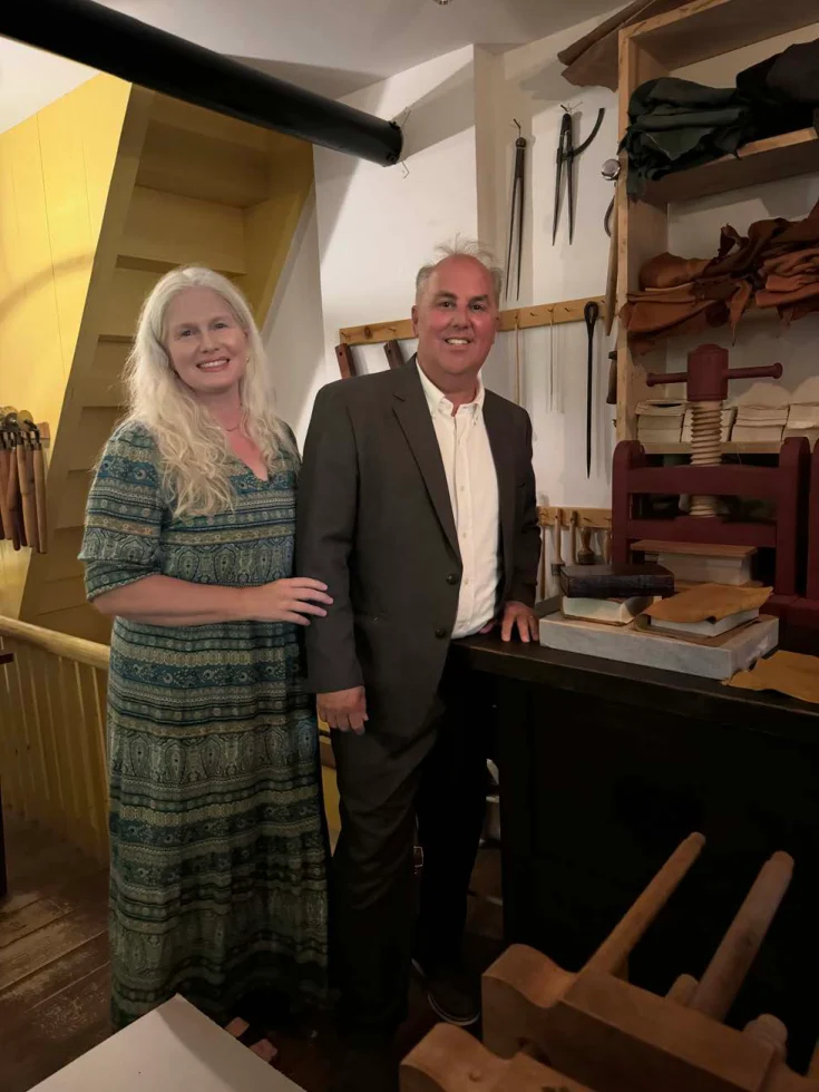 Rick and Amy beside a historical printing press
